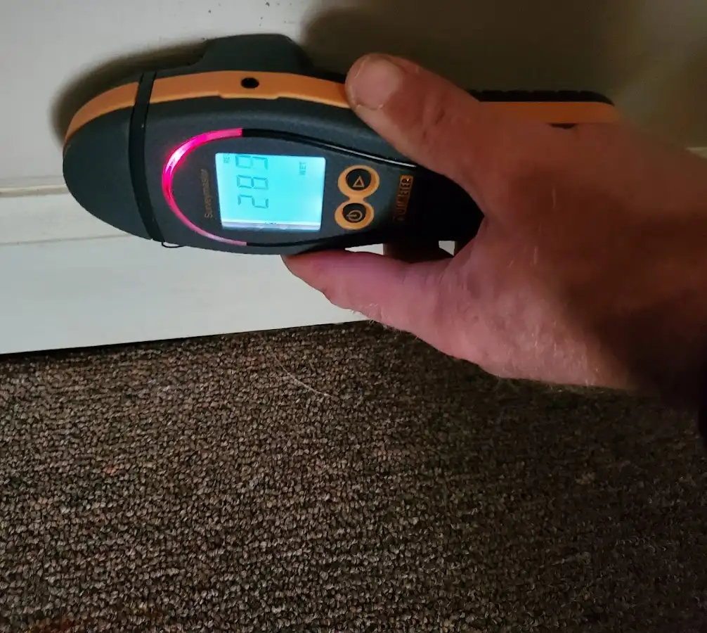 Moisture detection at baseboard during Storm Damage Restoration in Swainsboro